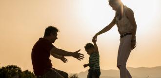 Mother and father holding childrens hand