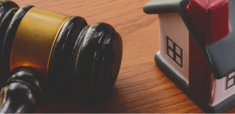 Gavel and miniature house