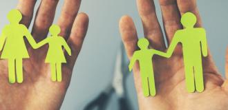 Two hands holding divided paper chain people