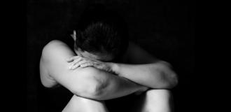 Woman with her head in her arms