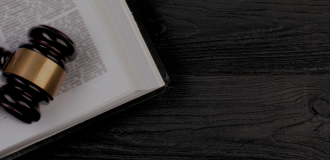 Gavel and open book on a black table