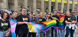 Group of people holding Pride flags