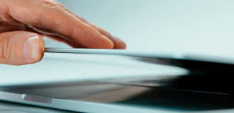 close up of a hand closing a laptop