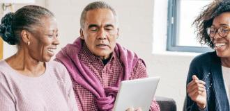 an elderly couple sat speaking to a lawyer