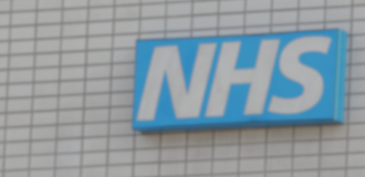 NHS Logo on the side of a hospital