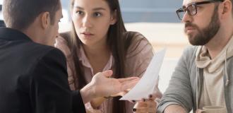 Couple looking stressed speaking to lawyer