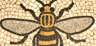 A colourful mosaic of the Manchester Bee on the ground.