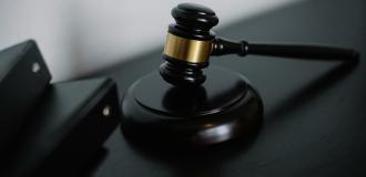 Close-up of a wooden gavel on a desk, symbolizing justice and legal authority.
