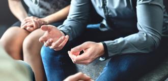 Parents siting together in discussion.