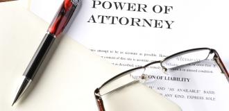 power of attorney pen and glasses on document