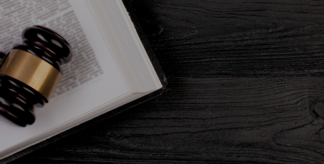 Gavel and open book on a black table