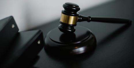 Close-up of a wooden gavel on a desk, symbolizing justice and legal authority.