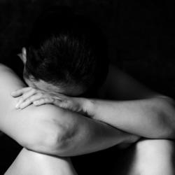 Woman with her head in her arms
