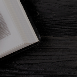 Gavel and open book on a black table