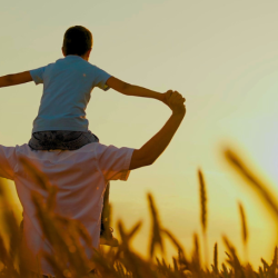 Child on fathers shoulders