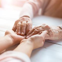 Two people holding both hands.