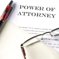 power of attorney pen and glasses on document
